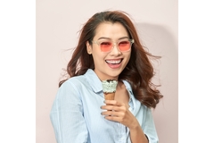 Image Smiling woman in sunglasses holding an ice cream cone